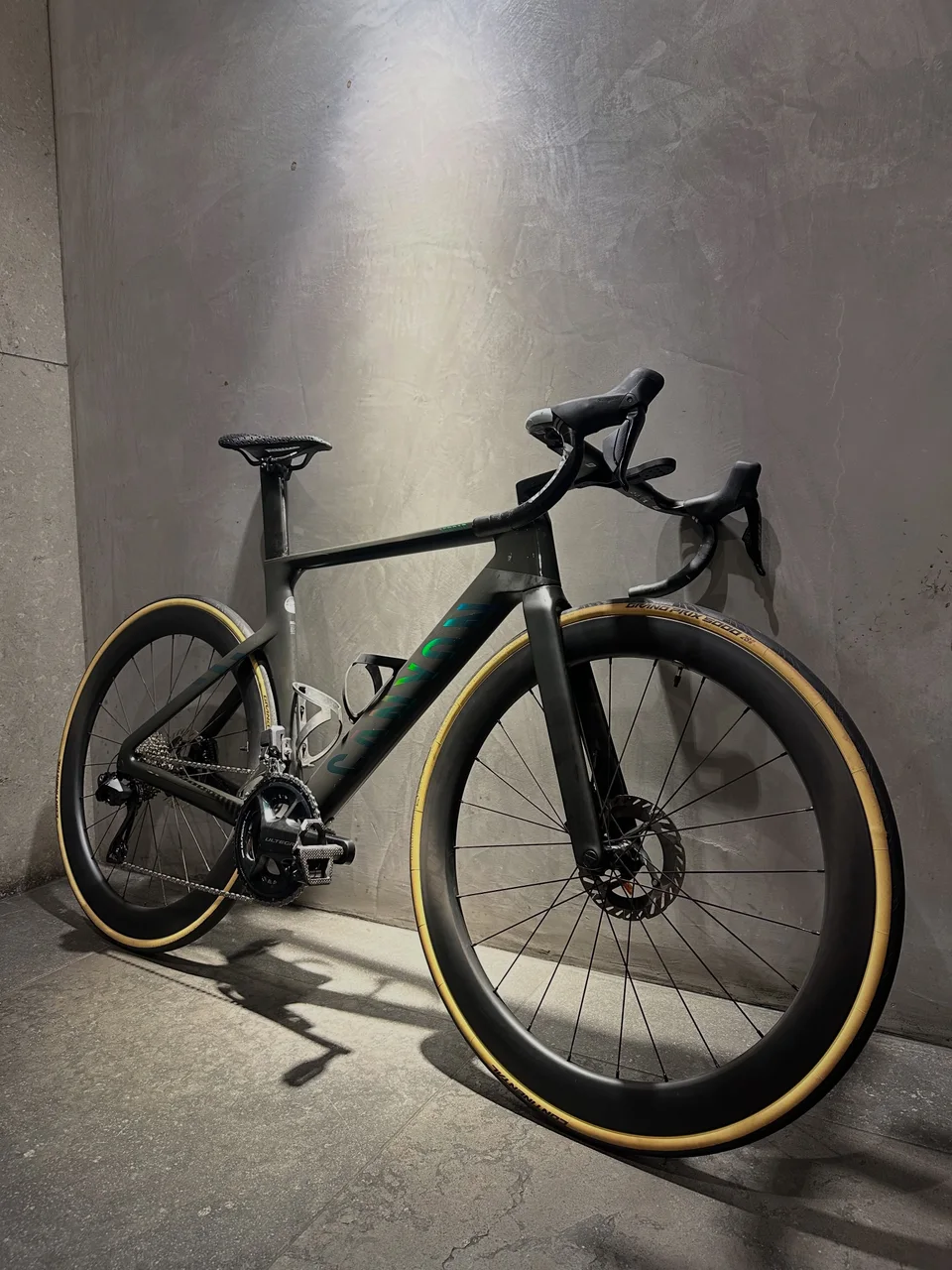 Silver Cervélo road bike with tan-wall tyres in the studio